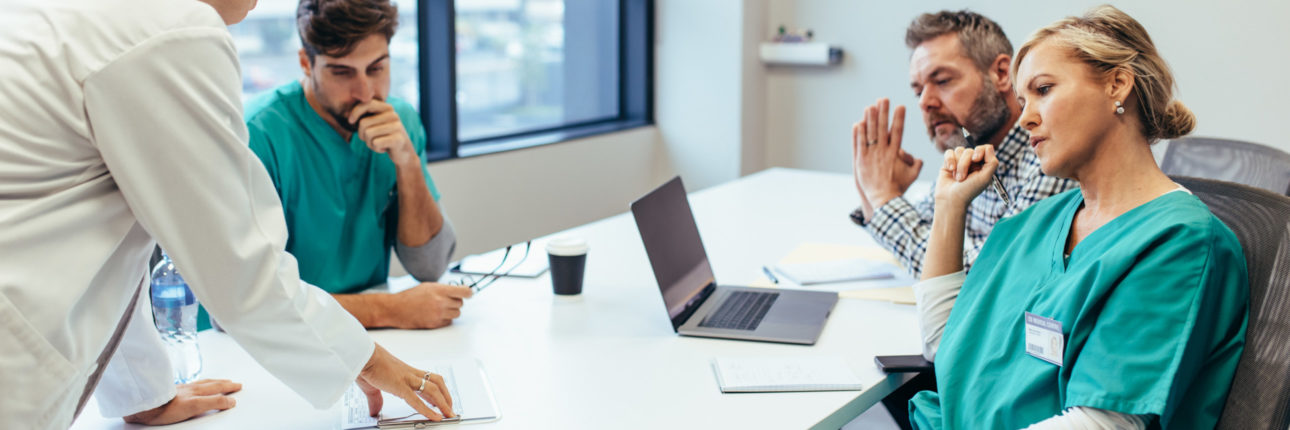 Group of medical professionals brainstorming in a meeting.