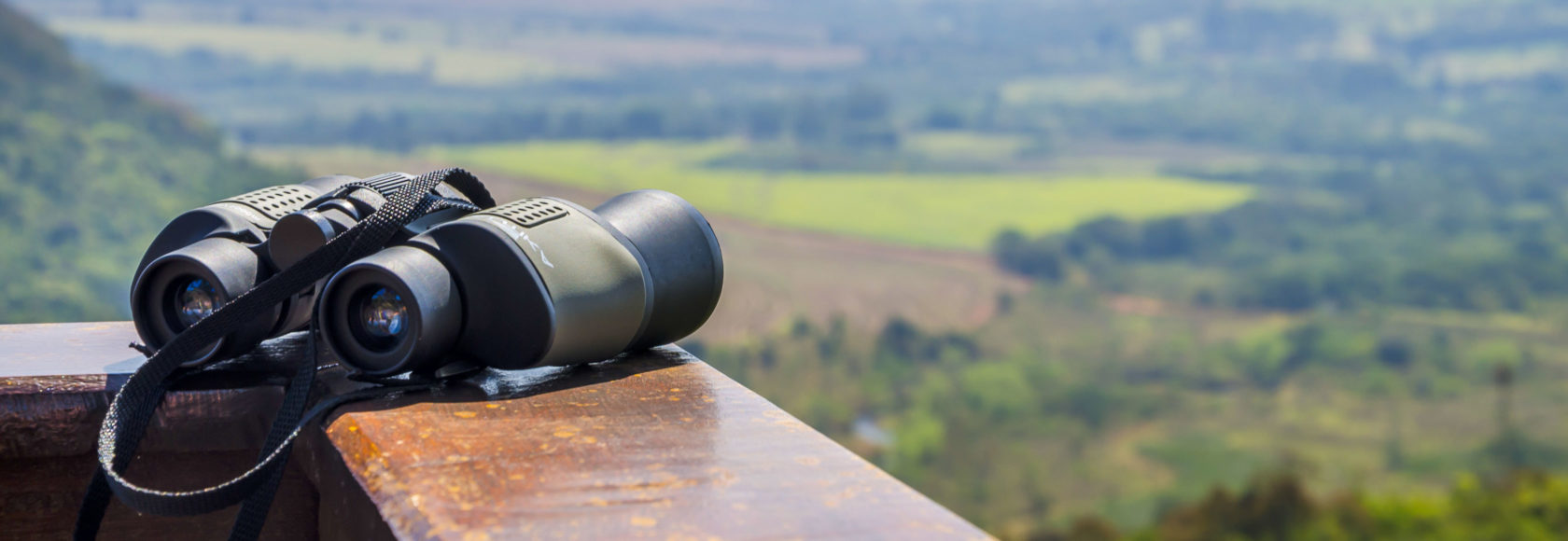 A pair of binoculars on a railing.