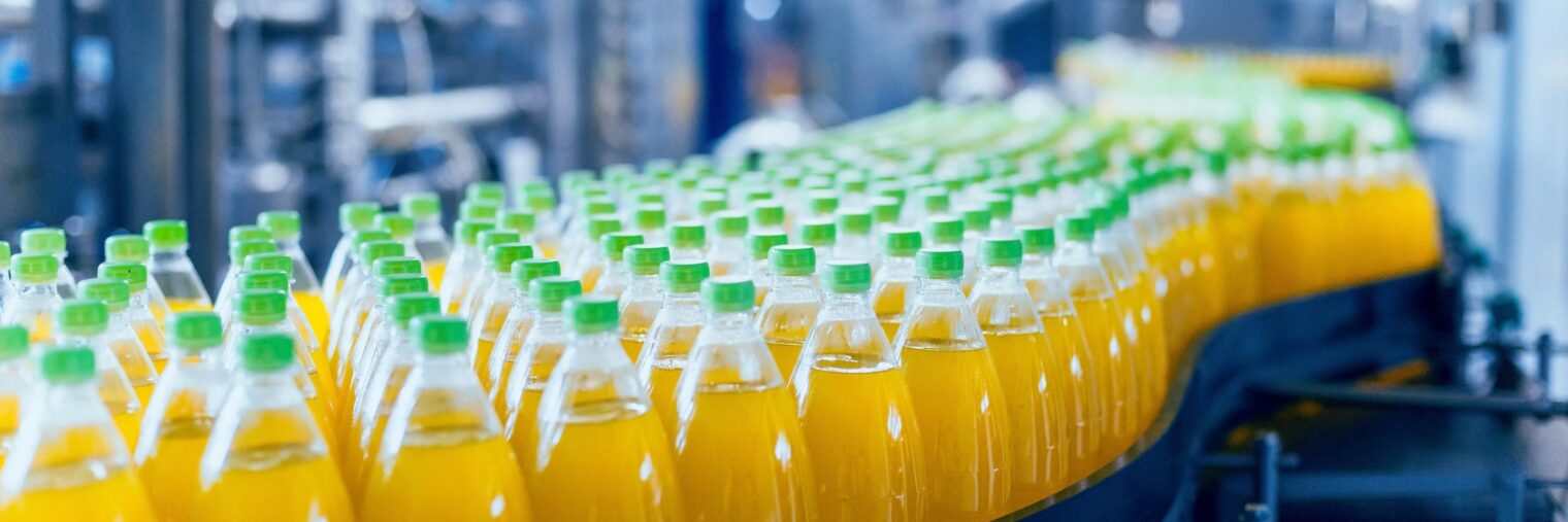 Conveyor with bottles for juice or water. Beverages factory equipment