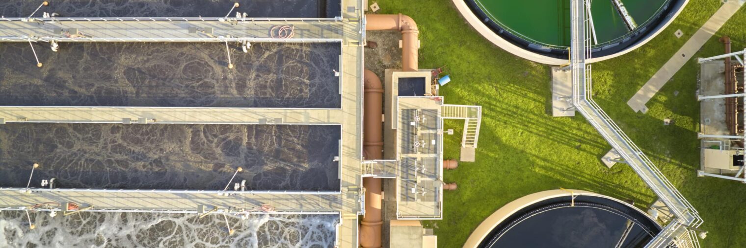 Aerial view of modern water cleaning facility at urban wastewater treatment plant. Purification process of removing undesirable chemicals, suspended solids and gases from contaminated liquid